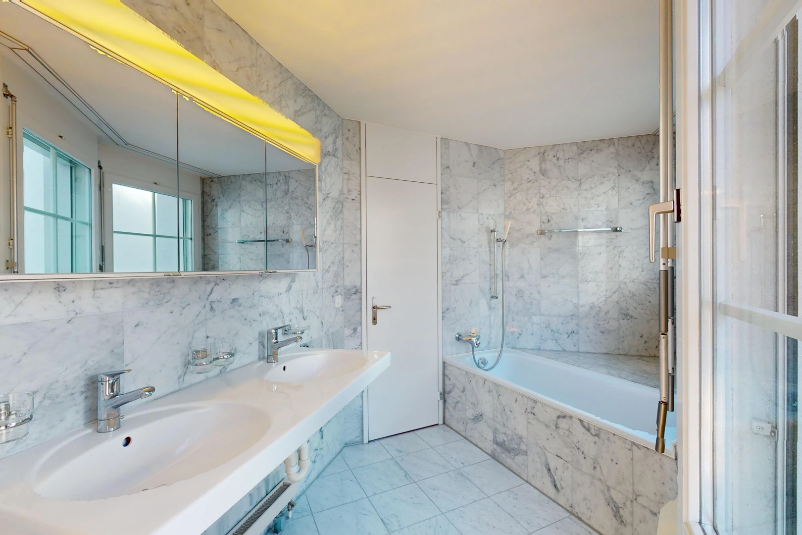 bad mit fliesenboden, spiegel, kombiniertes bad / dusche, doppelwaschbecken, und natürliches licht