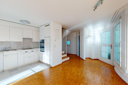 küche mit küchenrückwand beim herd, arbeitsplatten, ofen, weiße schränke, und waschbecken