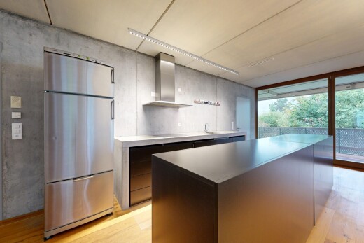 kitchen with stainless steel fridge, light wood-style flooring, a kitchen island, access to exterior, and modern cabinets