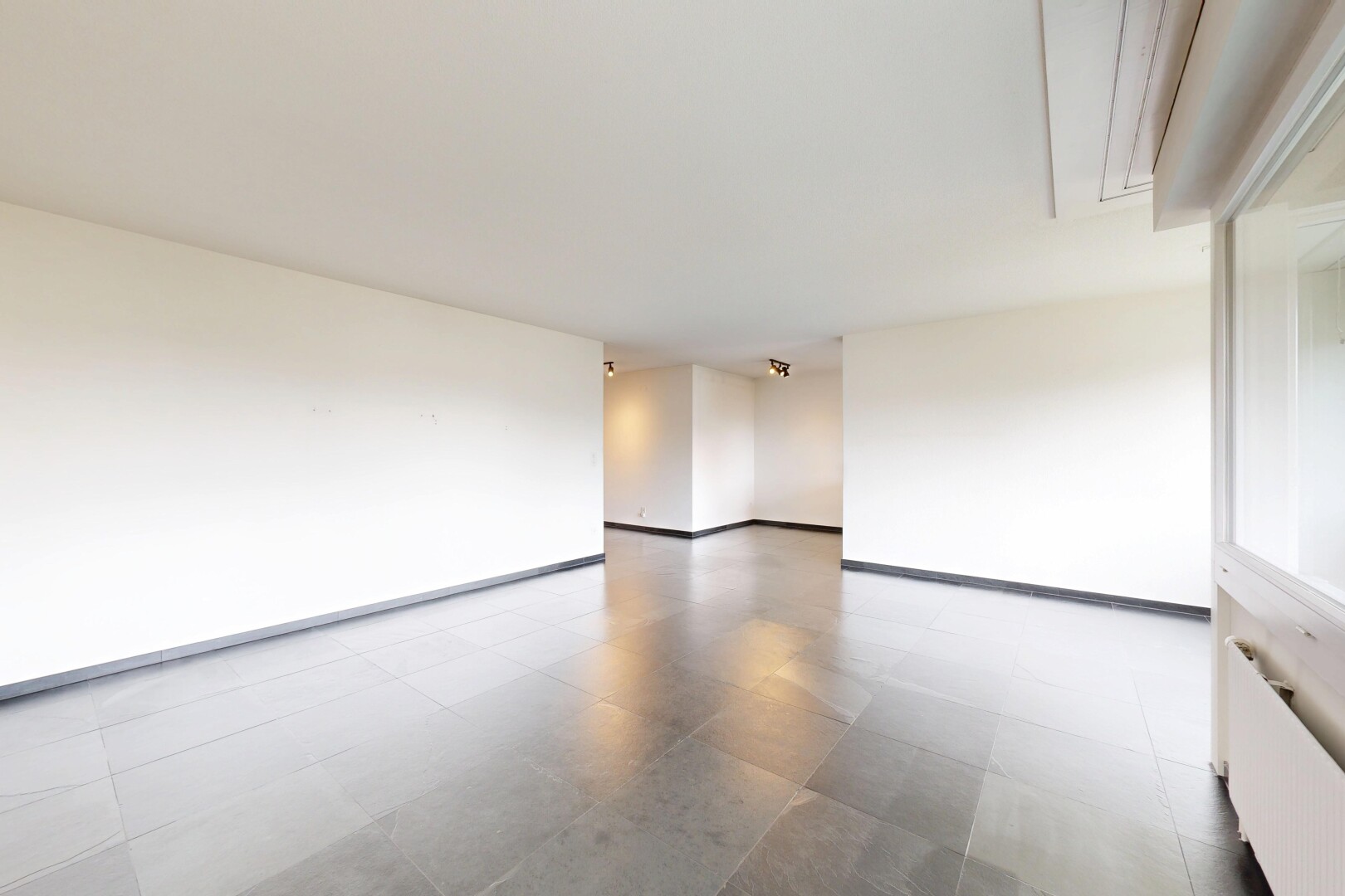 empty room with light floors and attic access