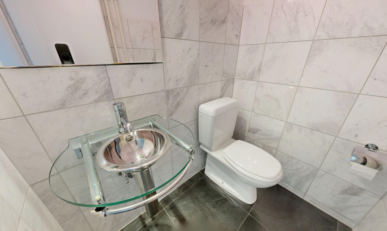 half bath featuring tile walls and tile patterned floors