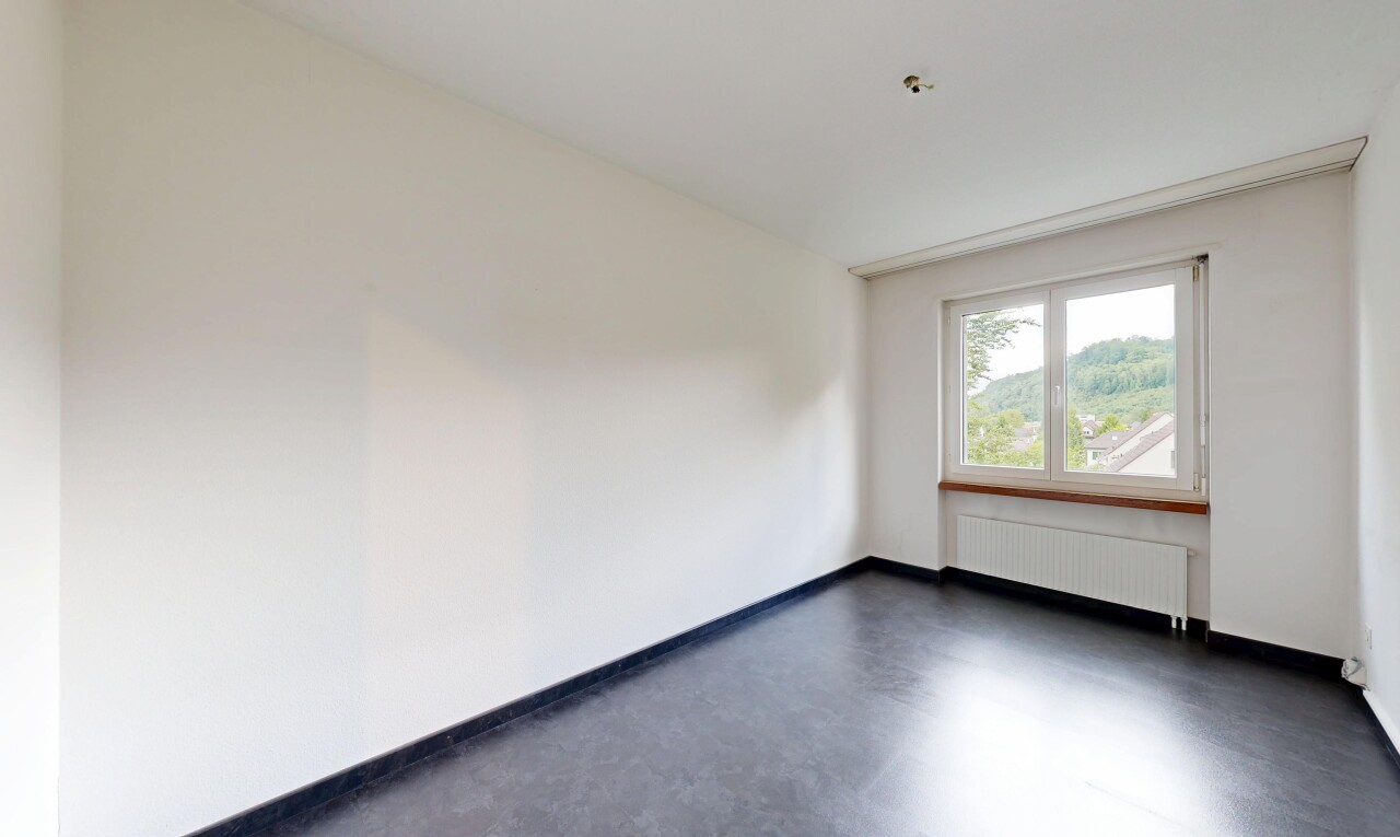 spare room featuring concrete flooring and radiator heating unit