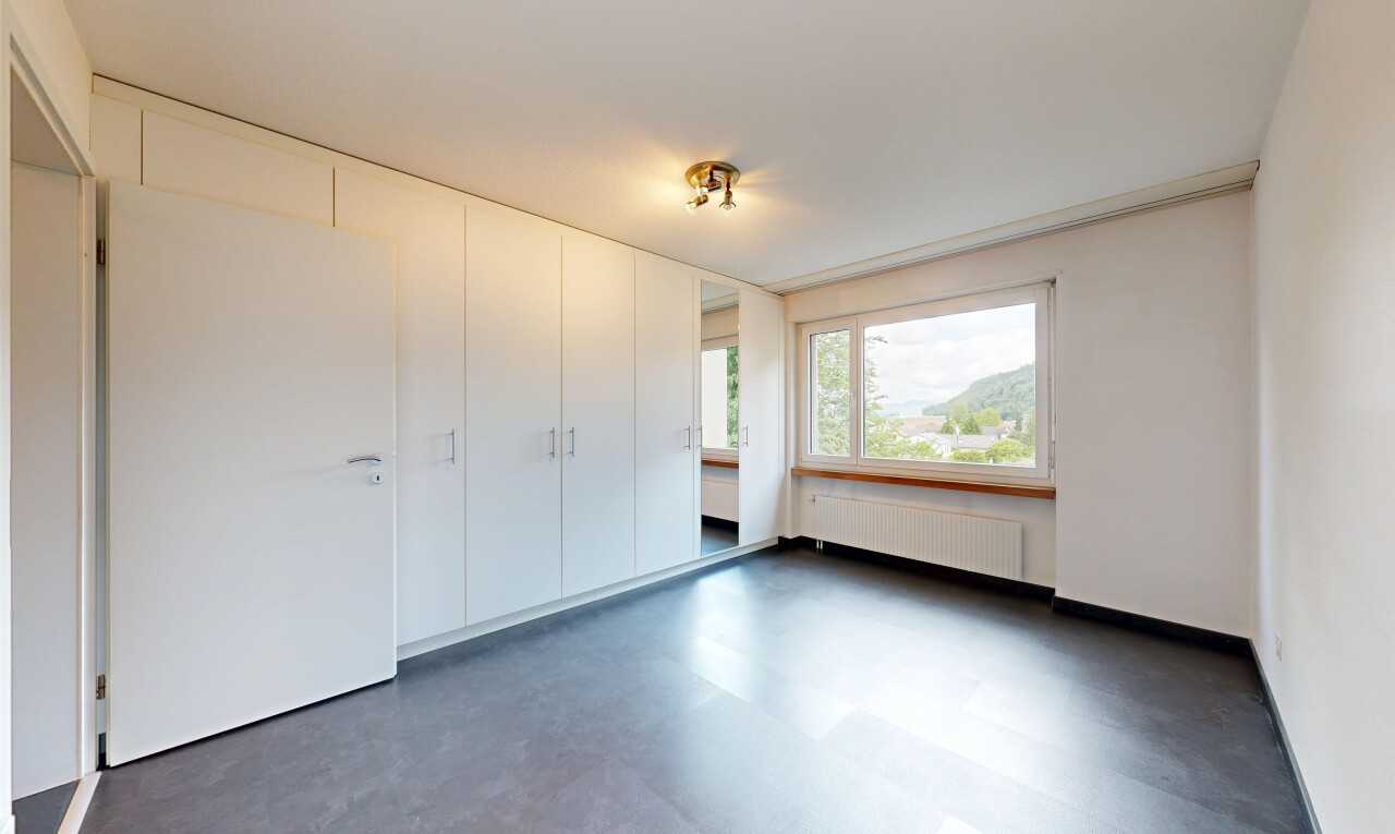 empty room featuring radiator heating unit and dark flooring
