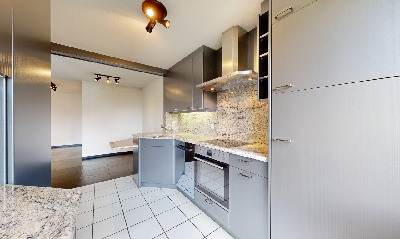 kitchen featuring decorative backsplash, light tile patterned floors, light stone counters, oven, and modern cabinets