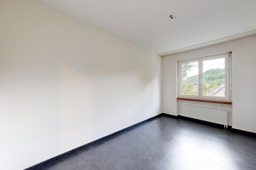 spare room featuring concrete flooring and radiator heating unit
