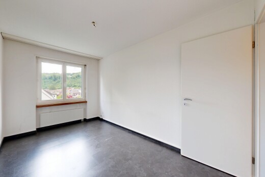 empty room featuring radiator heating unit and concrete floors