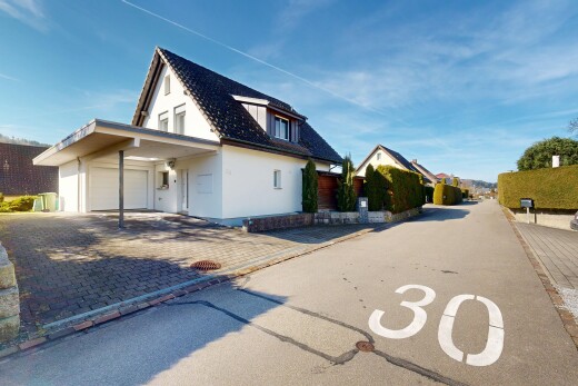 outdoor house with a garage, stucco siding, and driveway
