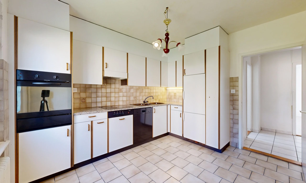 cuisine avec four, light floor, light countertops, dosseret, et backsplash
