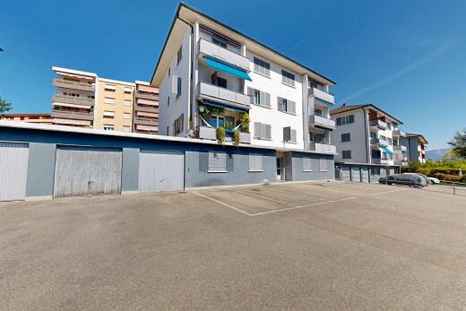 view of apartment building / complex with uncovered parking