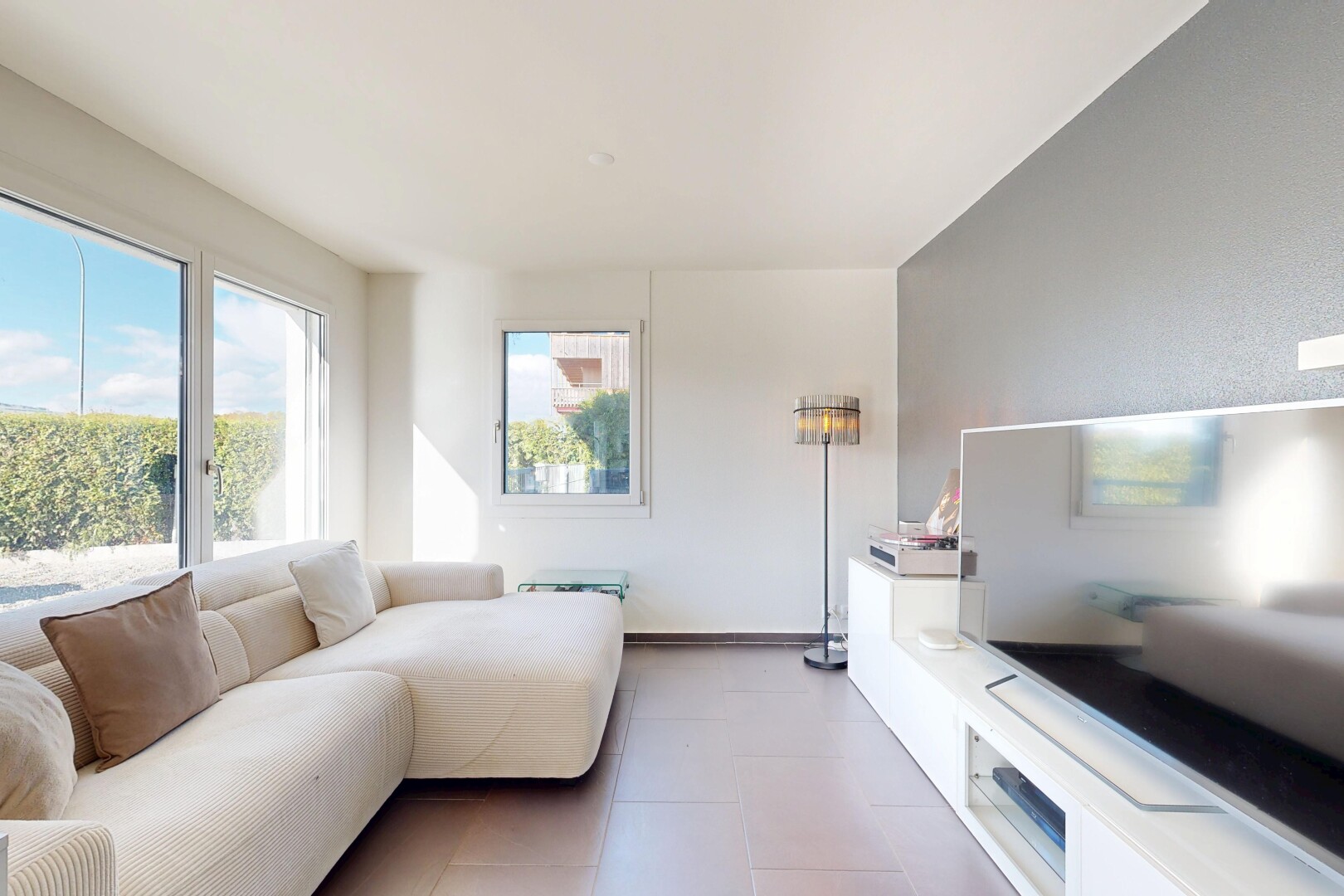 salon avec télévision, lumière naturelle, natural light, inside property, et day time