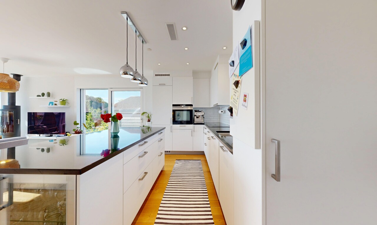 cuisine avec armoires à panneau plat, flat panel cabinets, plans de travail, dark countertops, et armoires blanches