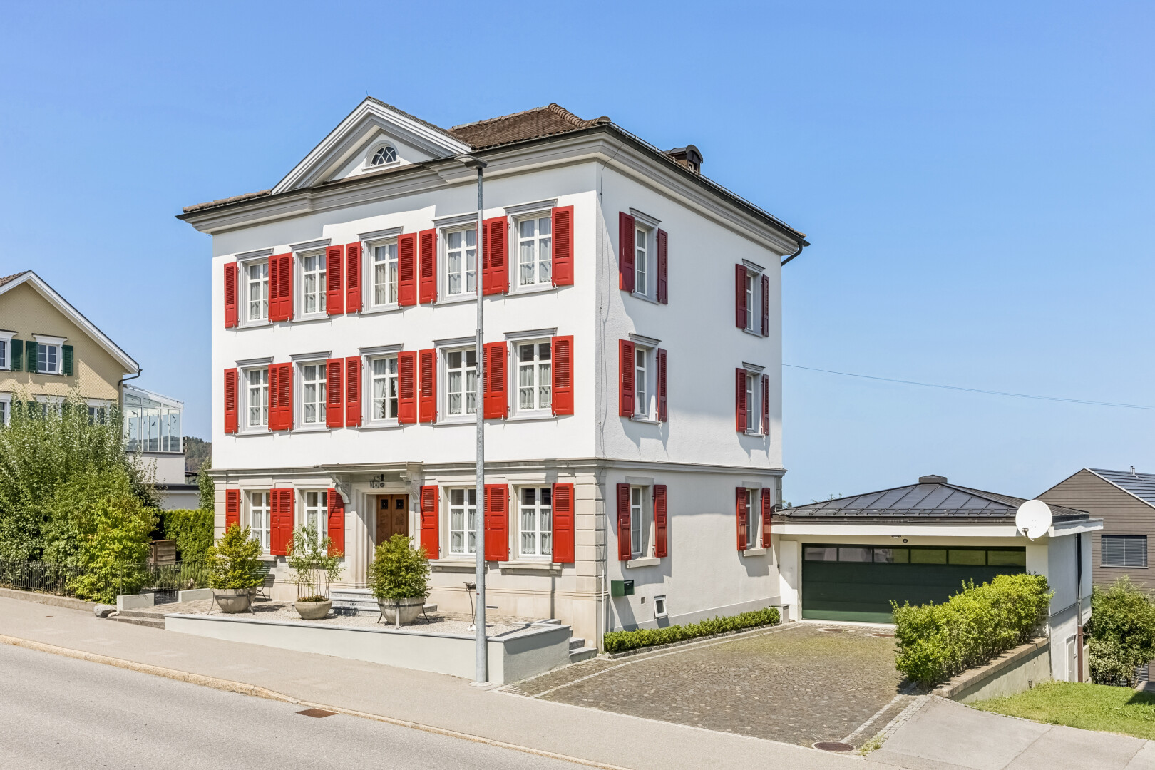 außenansicht mit day time, garage, property visible, und bordsteine