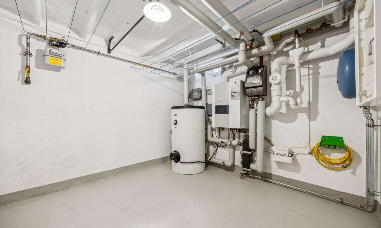laundry room with gas water heater