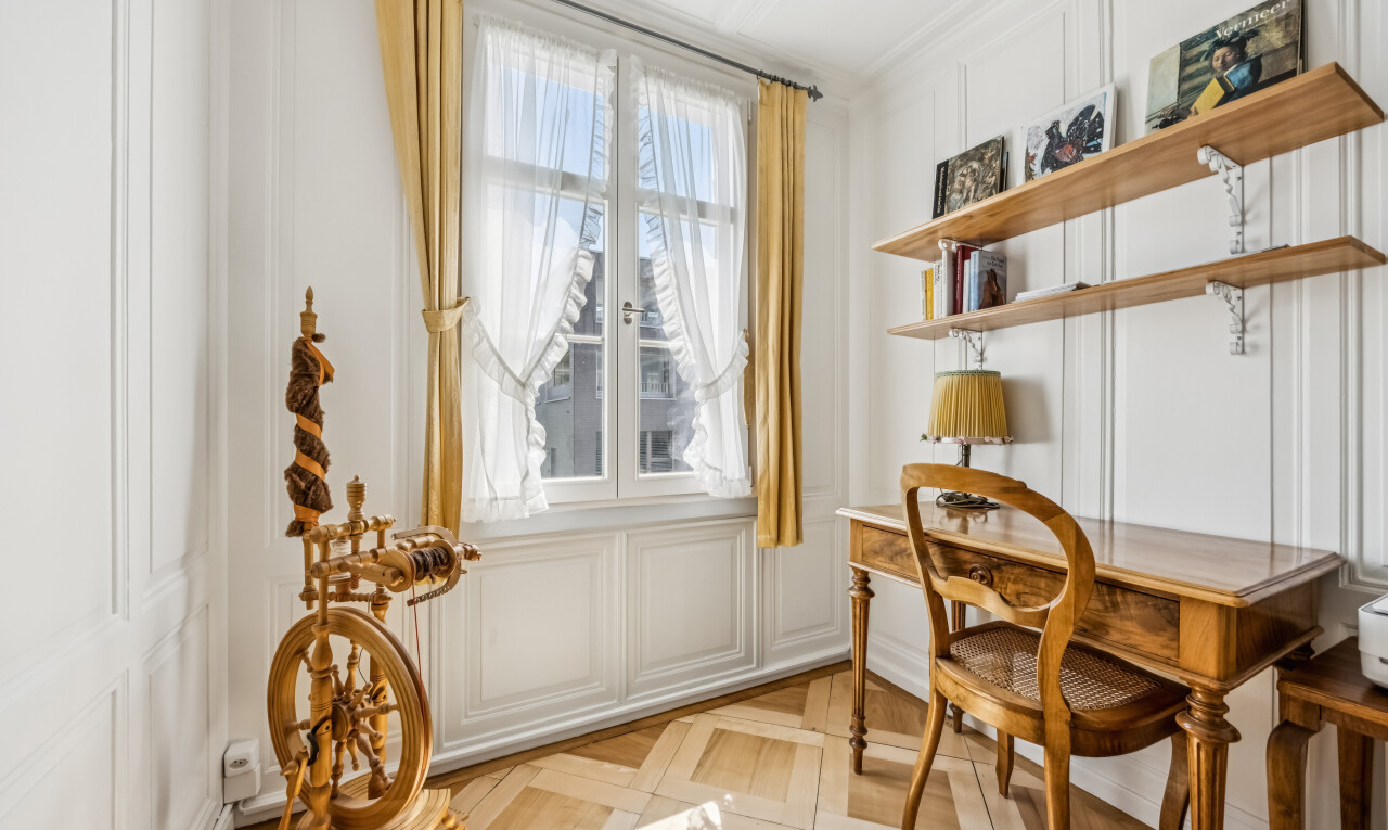 dining area featuring a decorative wall and parquet flooring