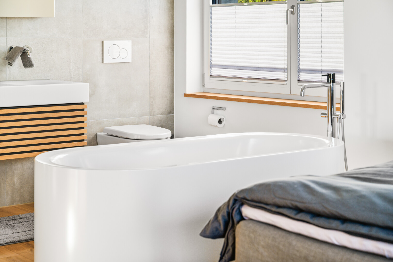 bathroom with tile walls, radiator heating unit, vanity, and a tub