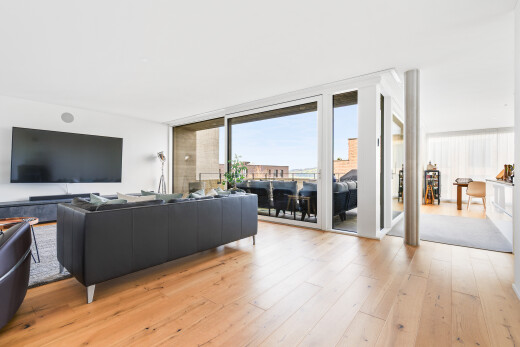 living room with light wood-style floors and expansive windows