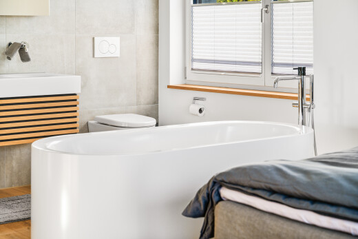 bathroom with tile walls, radiator heating unit, vanity, and a tub