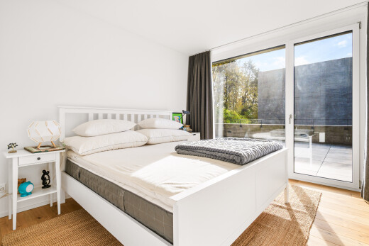 room / bedroom with light wood finished floors and access to exterior