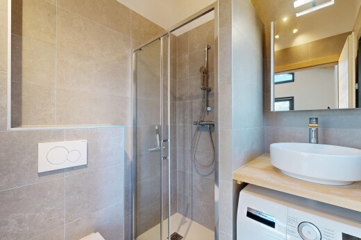 bathroom with washer / dryer, vanity, and a stall shower