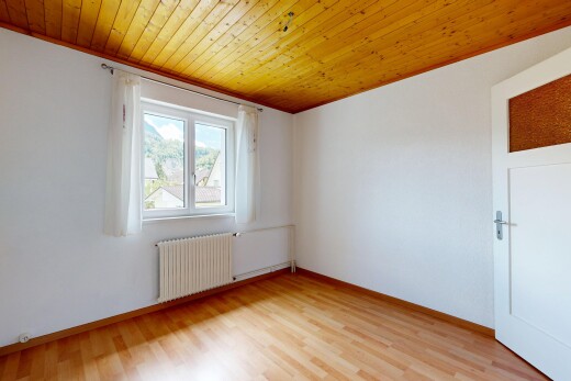empty room featuring wood ceiling, radiator, and light wood-style flooring