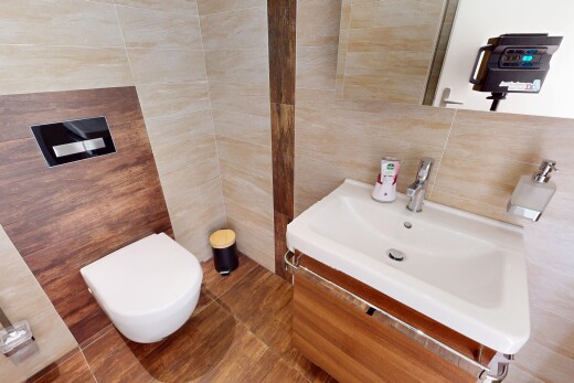 half bathroom featuring toilet, vanity, tile walls, and decorative backsplash