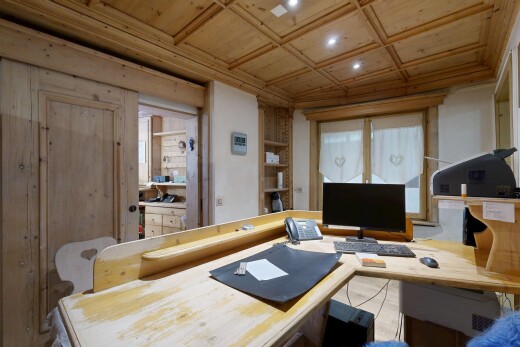 bureau avec wood ceiling, plafond en bois, étagères intégrées, télévision, et high end ceiling