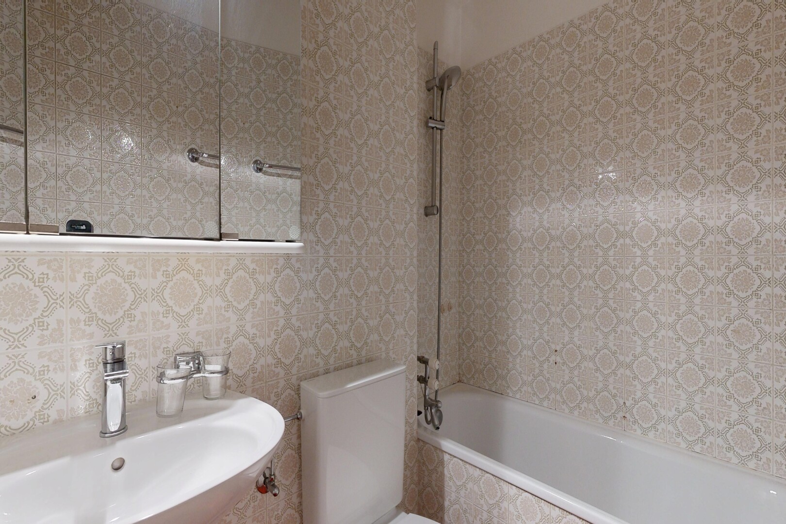 bathroom with a sink and tiled shower / bath combo