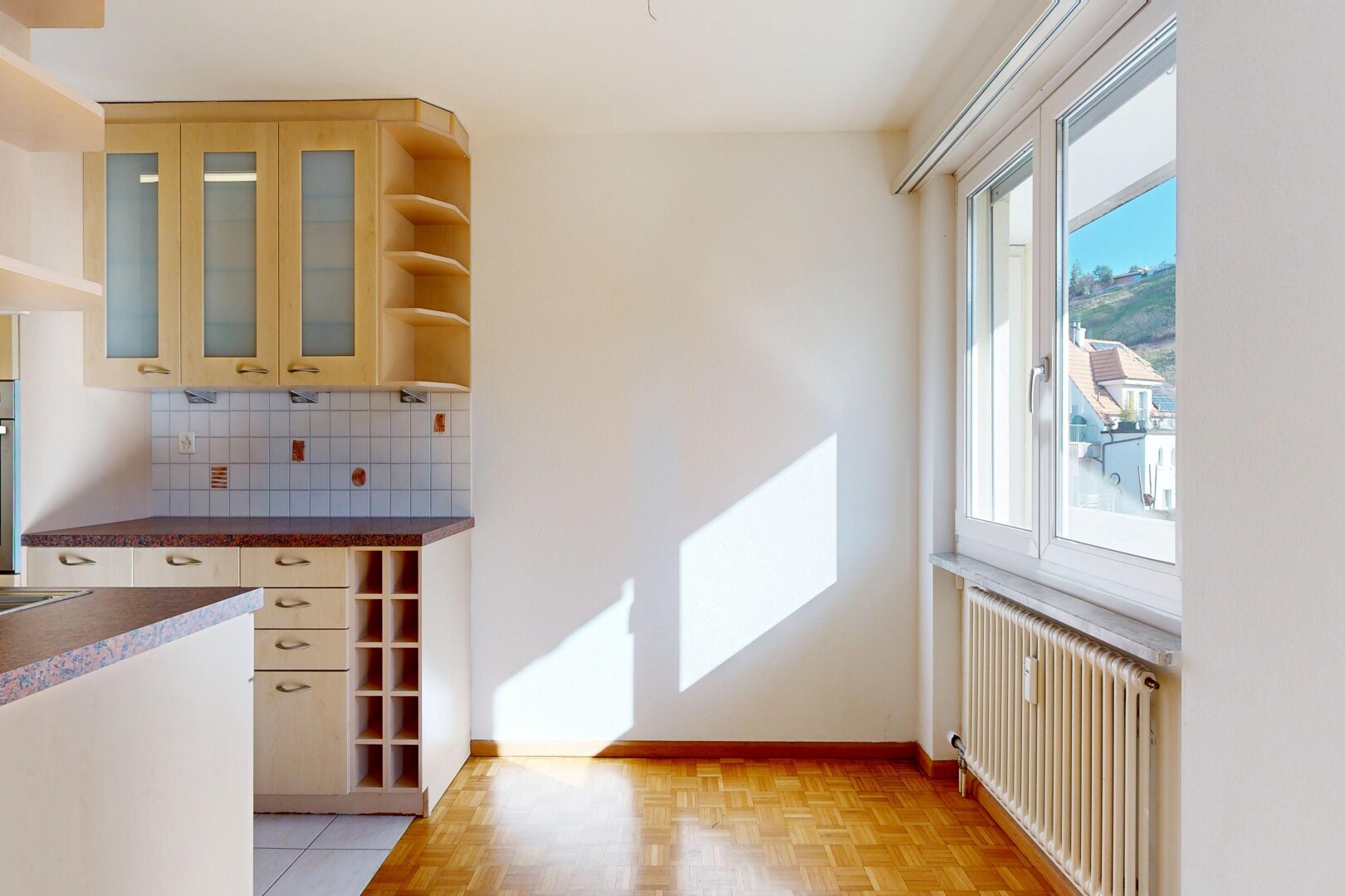 kitchen featuring open shelves, radiator, decorative backsplash, glass fronted cabinets, and parquet flooring
