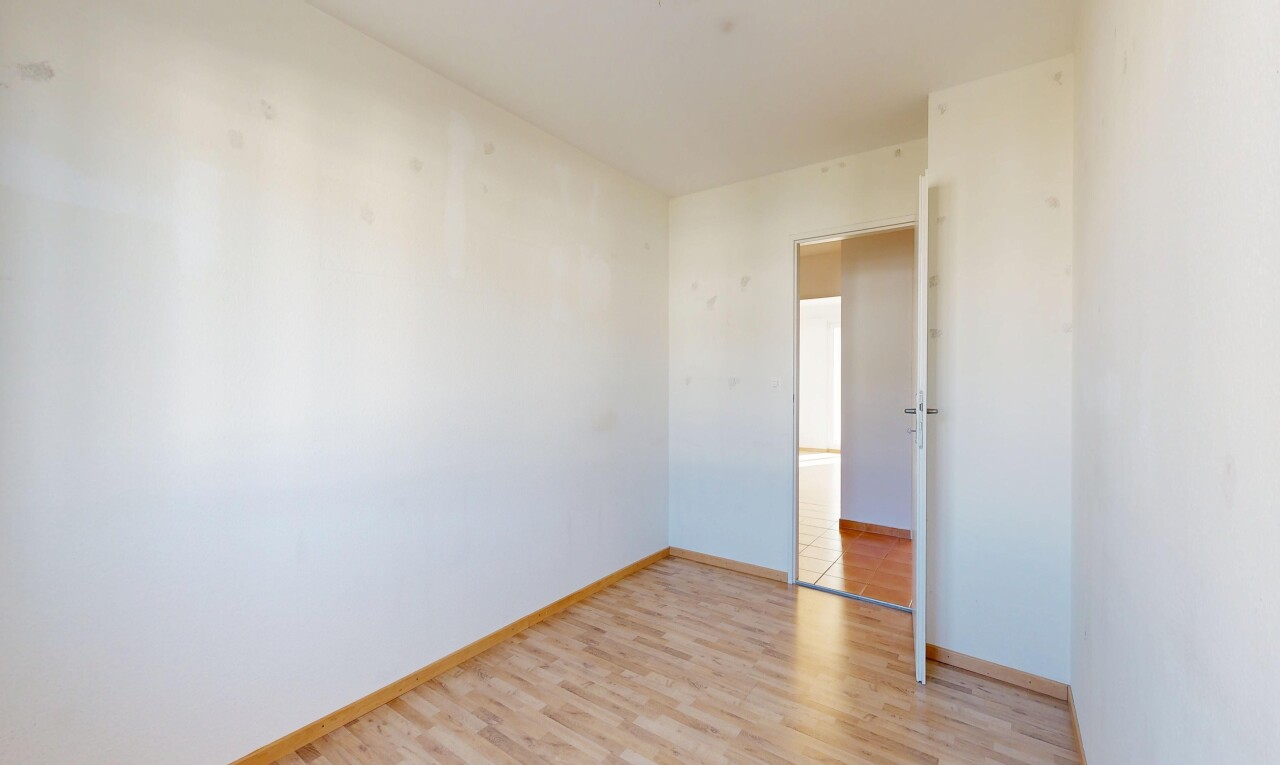 empty room featuring light wood-style flooring and baseboards