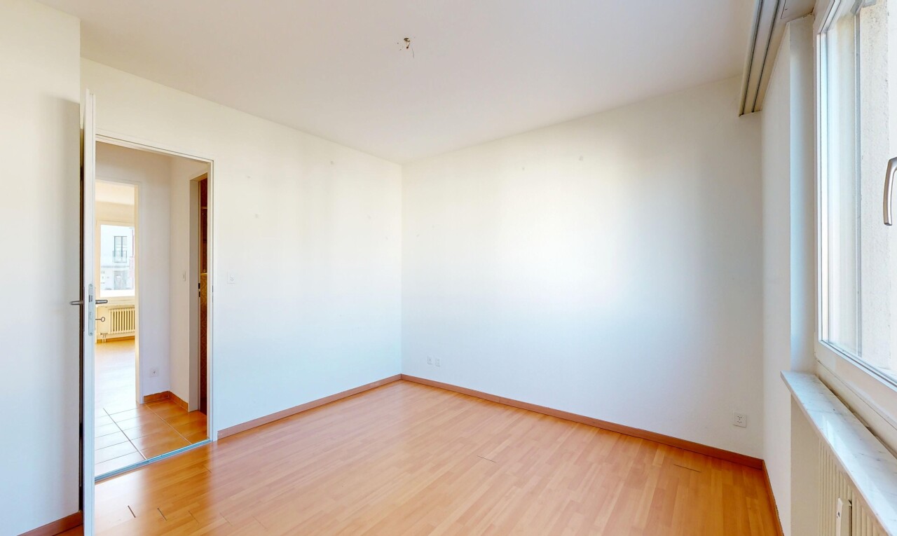 empty room with light wood-style flooring and radiator heating unit