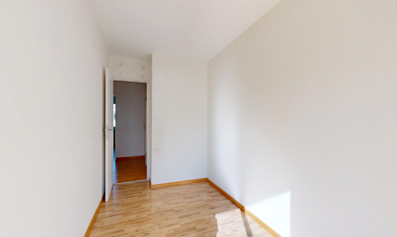 unfurnished room with light wood-style flooring and baseboards