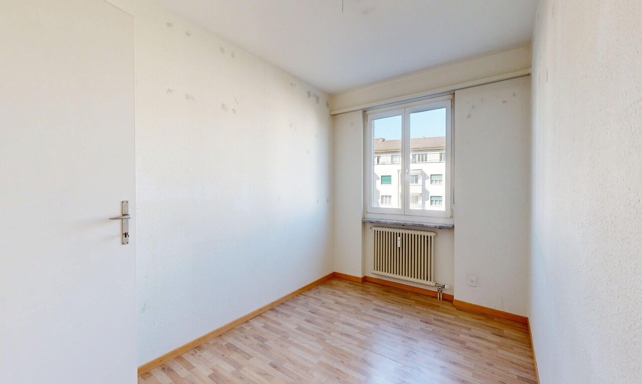 empty room featuring radiator heating unit and light wood-style floors