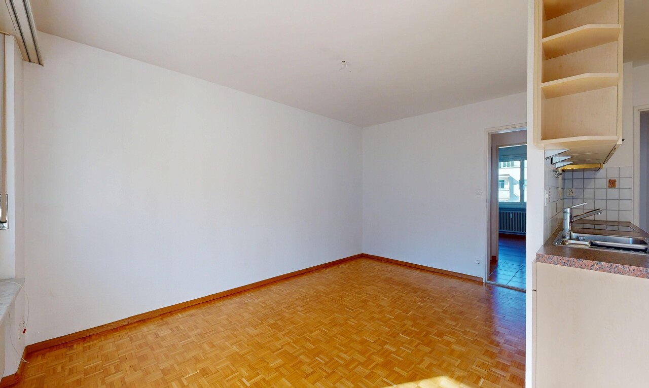 empty room featuring parquet flooring and radiator heating unit