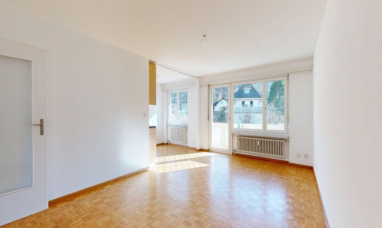 spare room featuring radiator and parquet flooring
