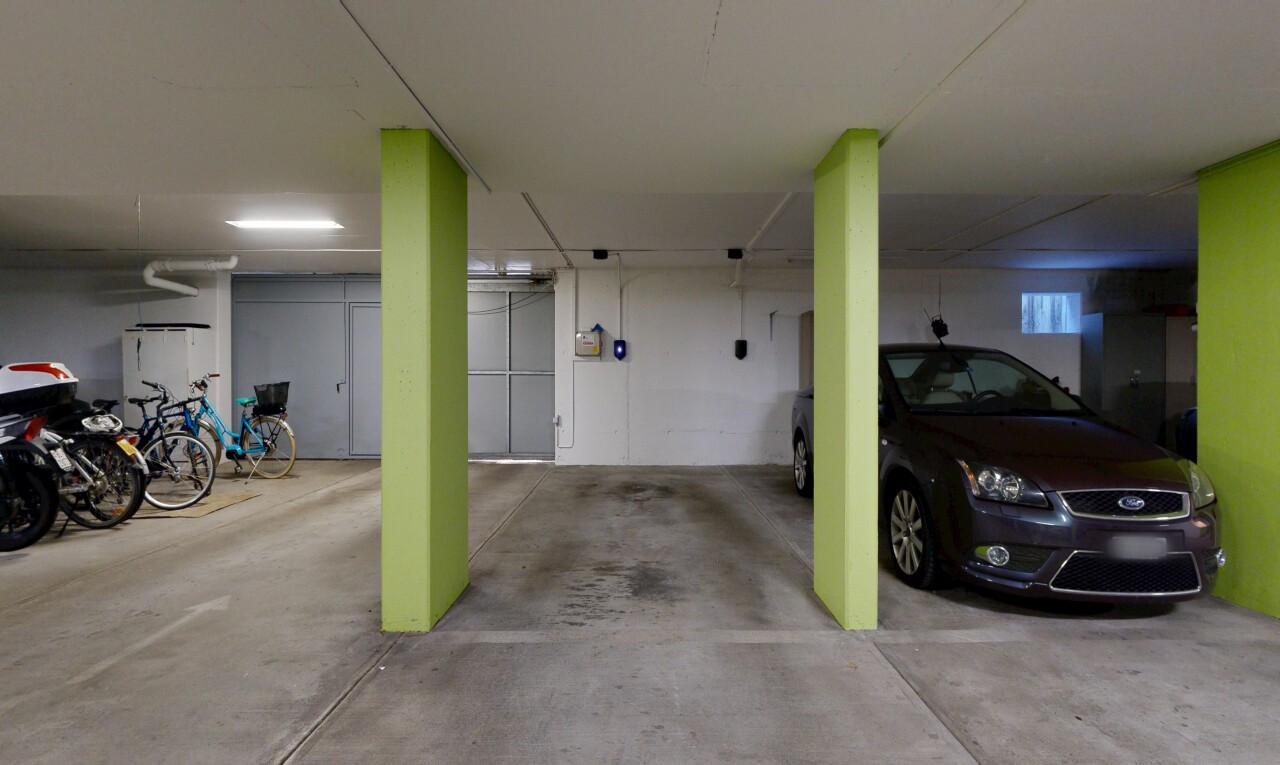 view of parking featuring a parking deck