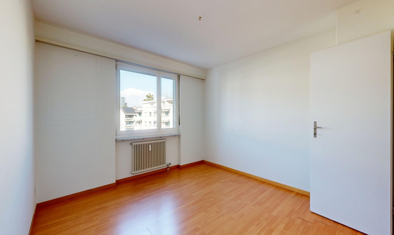 empty room featuring radiator heating unit and light wood-type flooring