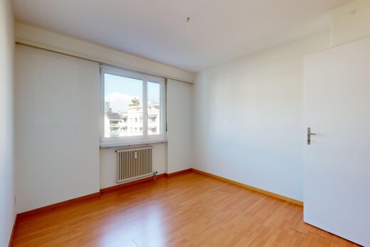 empty room featuring radiator heating unit and light wood-type flooring
