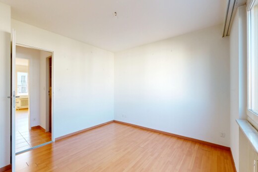 empty room with light wood-style flooring and radiator heating unit
