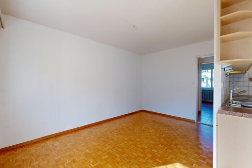 empty room featuring parquet flooring and radiator heating unit