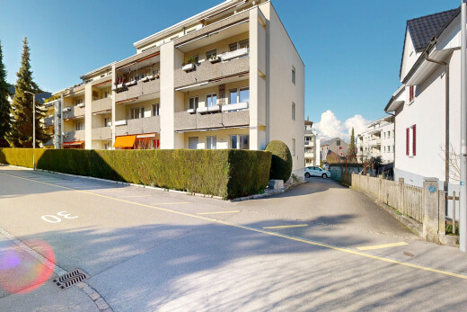 view of apartment building / complex with uncovered parking