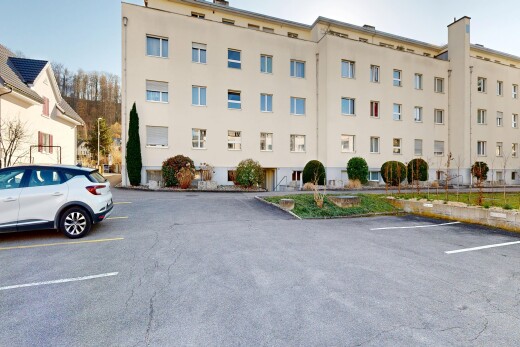 view of apartment building / complex with uncovered parking