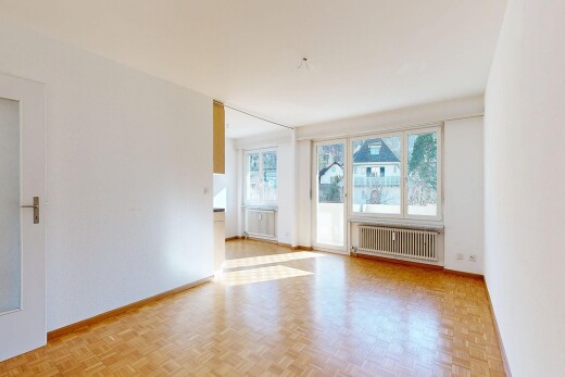 spare room featuring radiator and parquet flooring
