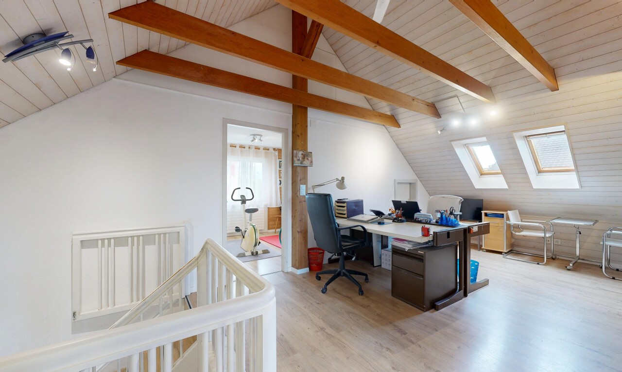 büro mit bürobereich, dachschräge, vaulted ceiling, holzfußboden, und wood finish floor