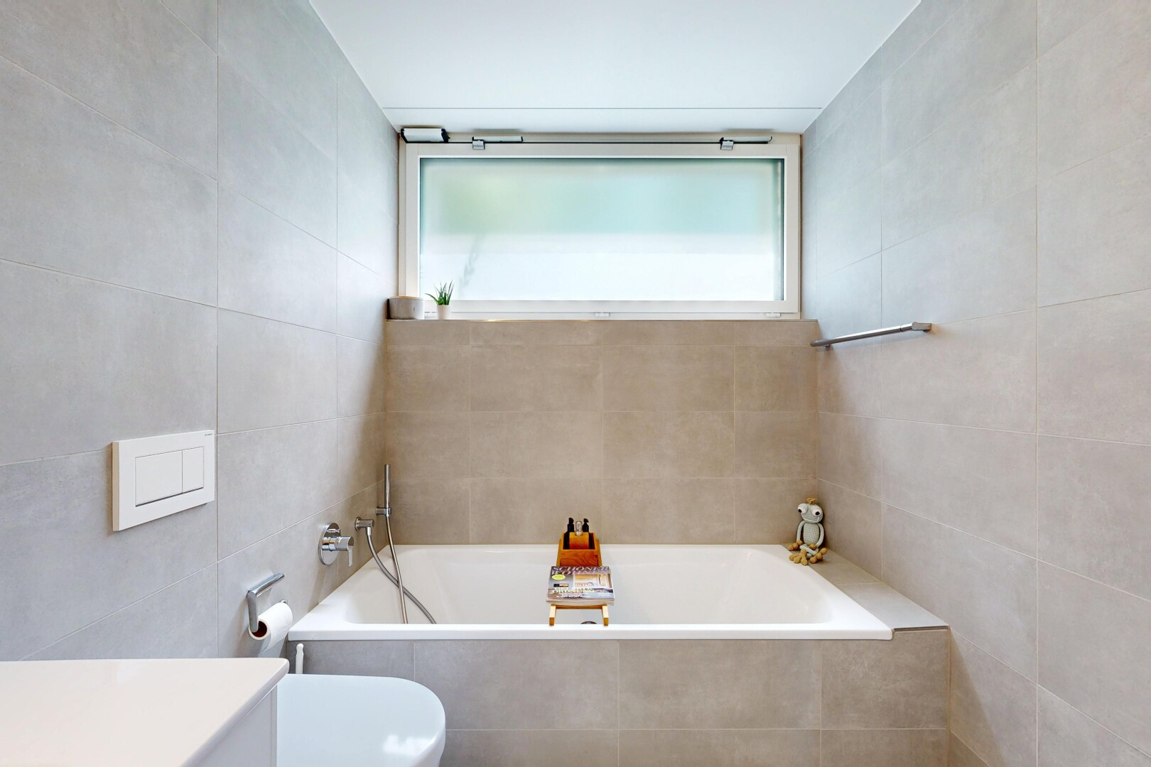 bathroom with tile walls, a bath, and vanity
