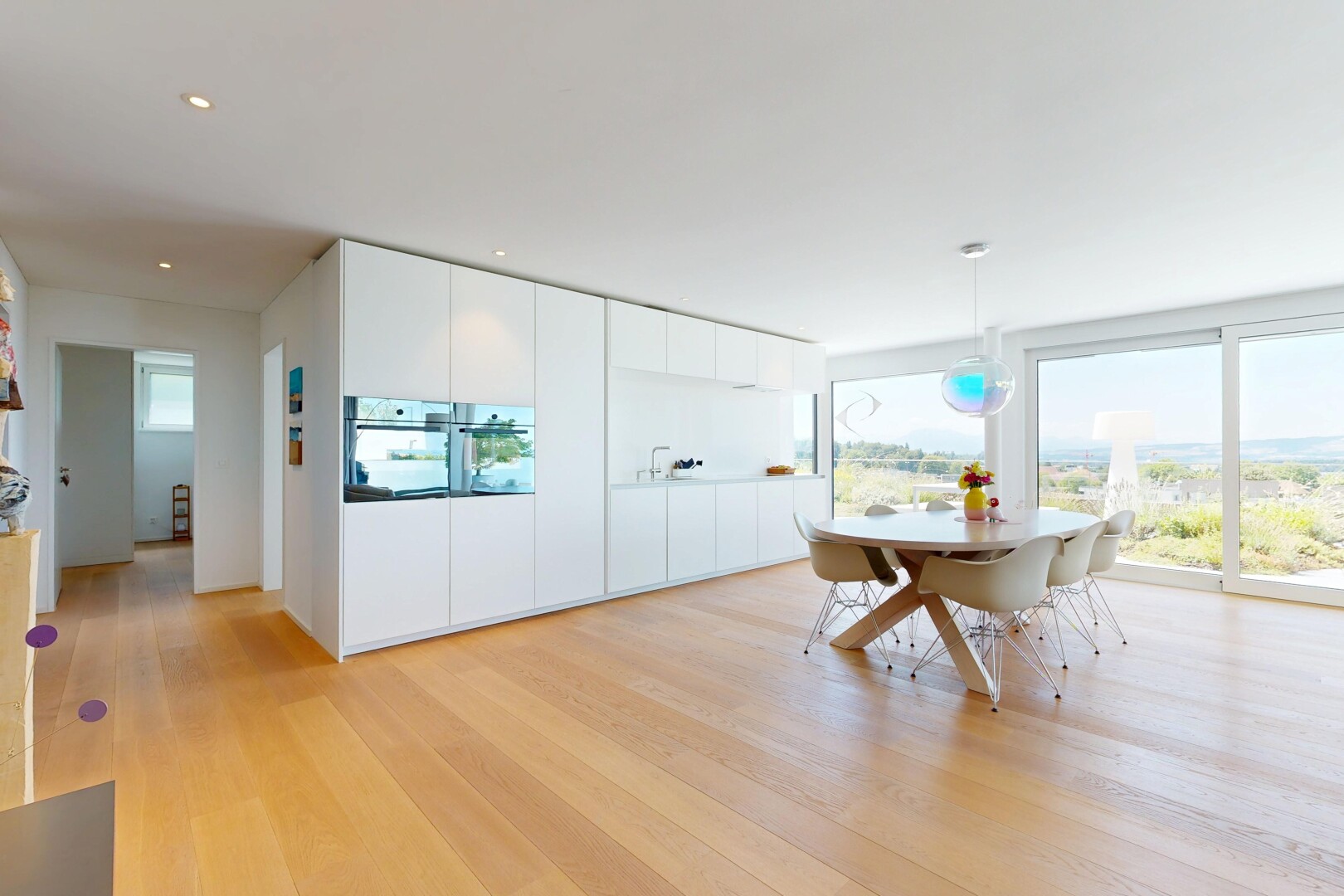 dining room with light wood-type flooring and pendant lighting