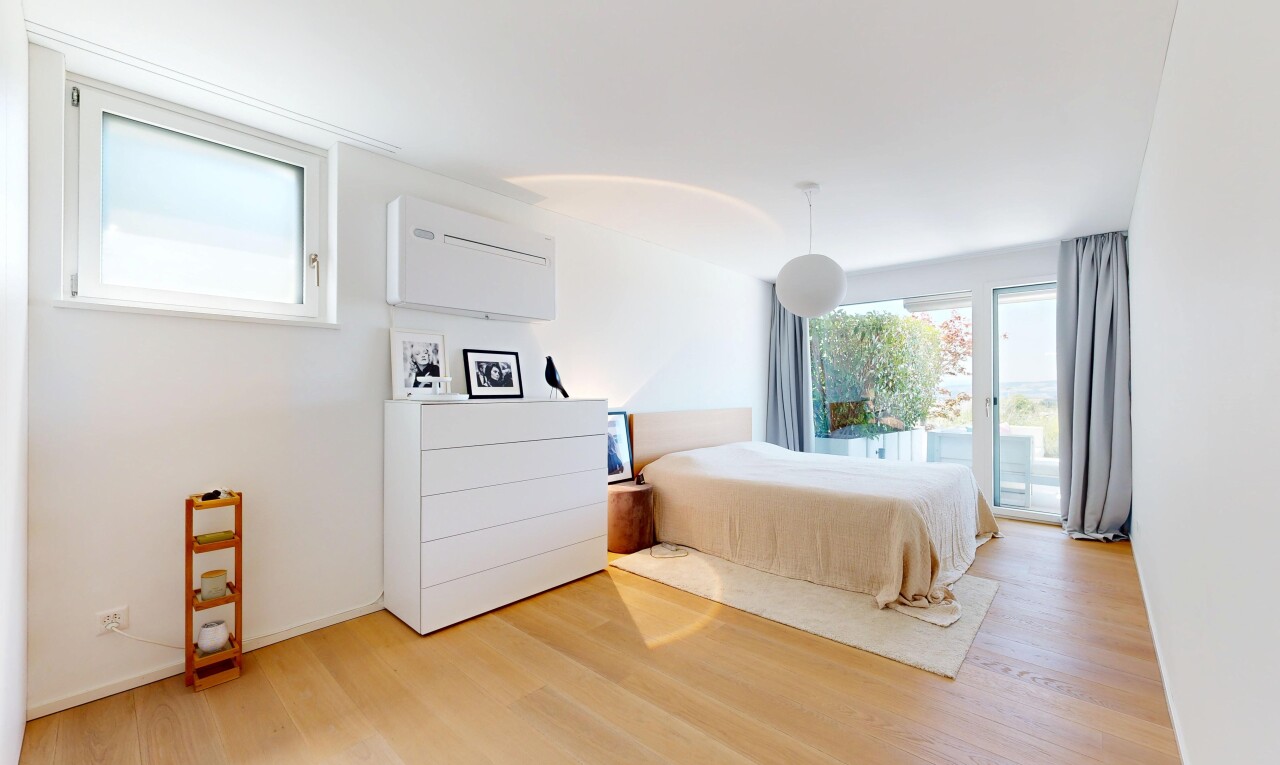 room / bedroom with pendant lighting, access to exterior, and light wood-type flooring