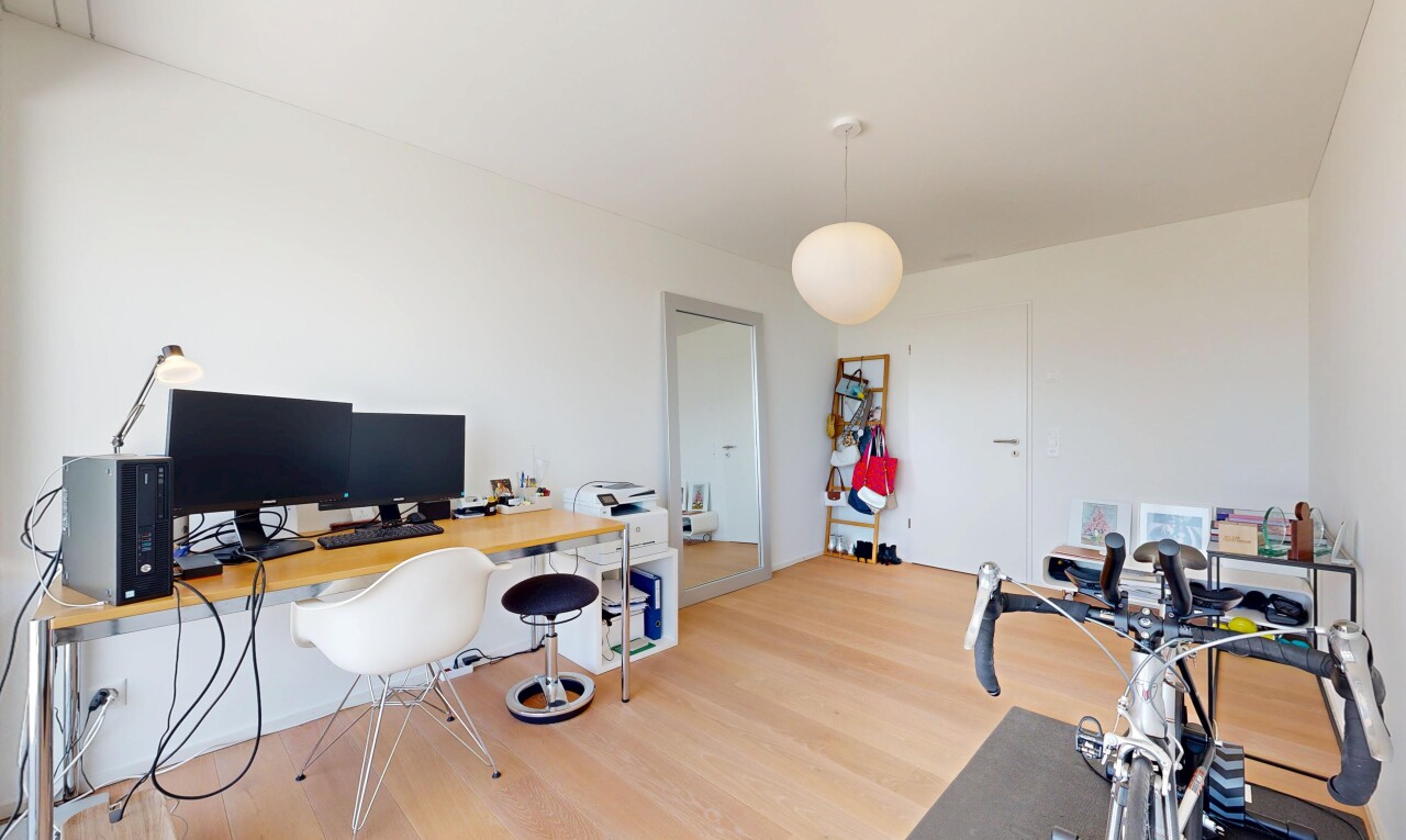 office area featuring decorative light fixtures and light wood-style floors