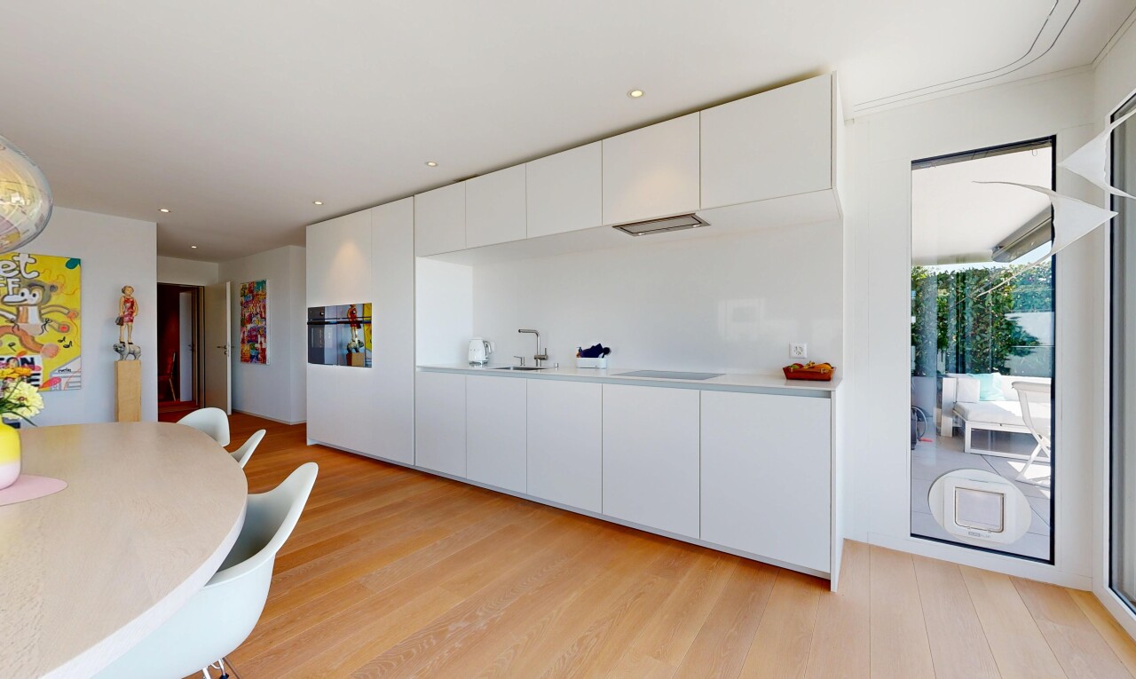 kitchen featuring modern cabinets, recessed lighting, light countertops, white cabinets, and light wood finished floors