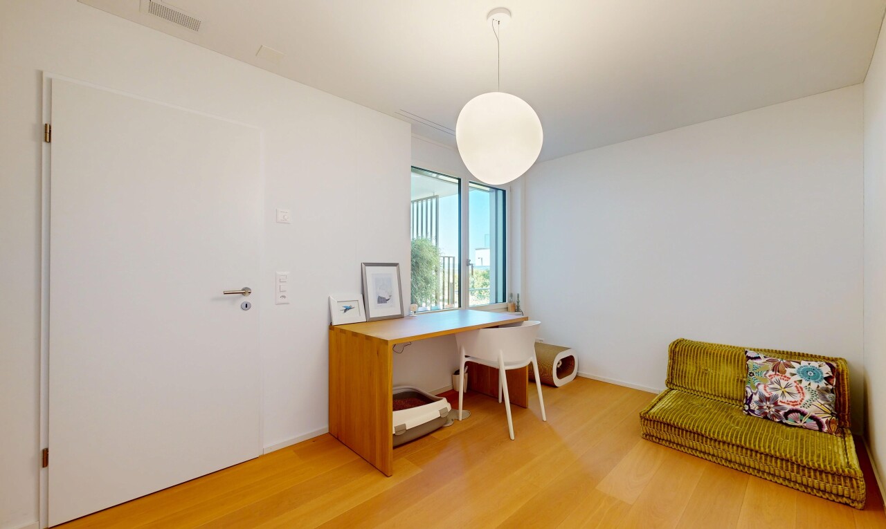office space featuring decorative light fixtures and light wood-style floors