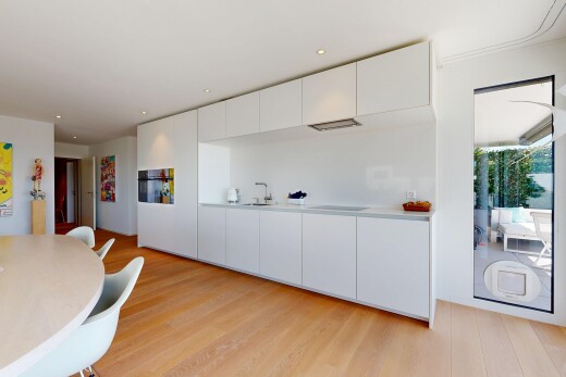kitchen featuring modern cabinets, recessed lighting, light countertops, white cabinets, and light wood finished floors
